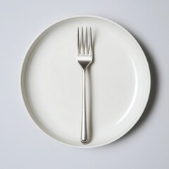 Silver fork on a white plate isolated on white background