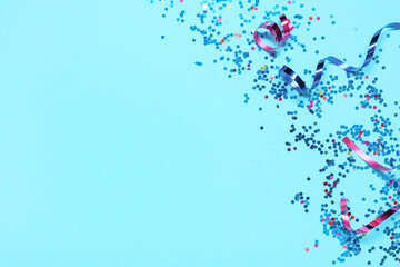 Beautiful confetti and serpentine on blue background