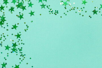 Beautiful green confetti on turquoise background