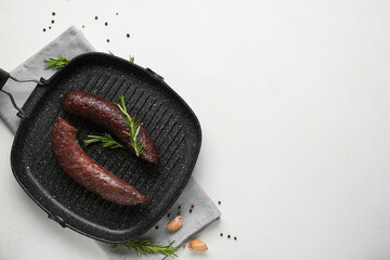 Grill pan with tasty blood sausage on white background