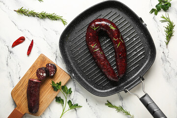 Grill pan with tasty blood sausage on white background