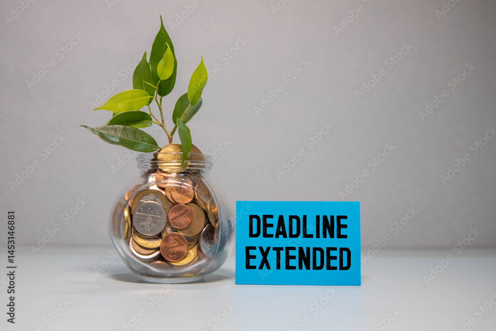 Poster text deadline extended on sticky notes with copy space and paper clip isolated on red background.