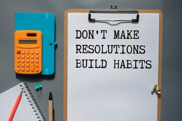 Wooden blocks with words 'Don't Make Resolutions Build Habits.