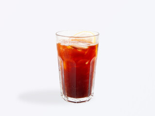 Iced black tea with lemon in clear glass
