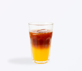 Layered iced espresso with orange juice in glass