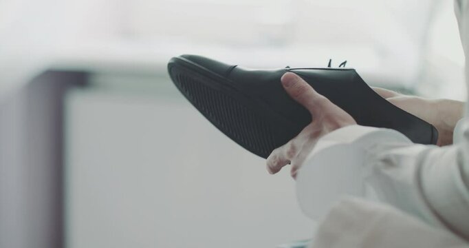 Man Unlaces Shoe Close-Up