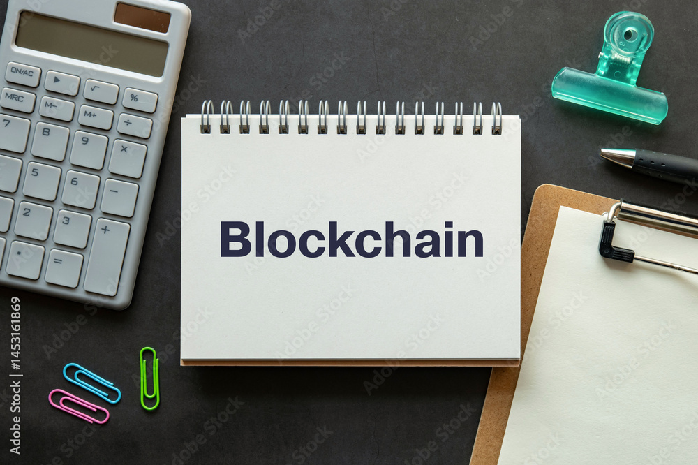 Poster there is notebook with the word blockchain. it is as an eye-catching image.