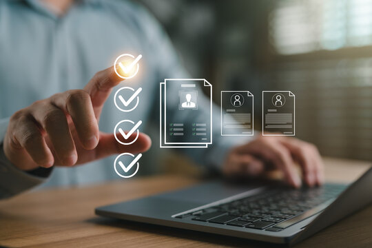 Businessman reviewing resumes and selecting candidates via digital checklist system on laptop, representing recruitment process, job application review, and HR digital transformation.