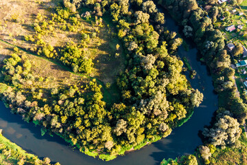 Flying over a river bend in the countryside
