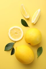 Fresh ripe lemons on yellow background, flat lay
