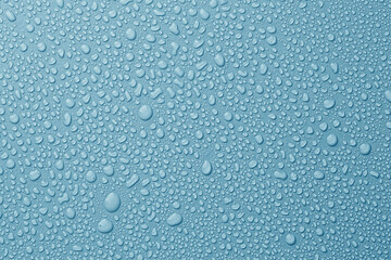 Many water drops on light blue background