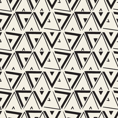 Vector seamless pattern with bold hand-drawn triangles in a tribal geometric style. Ideal for textiles, packaging, wallpaper, and ethnic-inspired designs