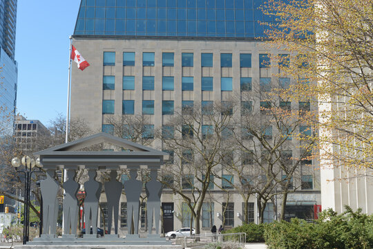 view of sculpture "Pillars of Justice", created by Edwina Sandys in 2007, standing outside the Courthouse at 361 University Av