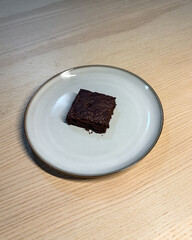 A piece of brownie on the plate.