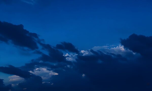 Stunning Blue Sky Canvas: A Serene Evening Sky with Dramatic Clouds