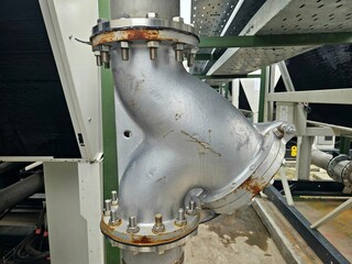 Close-up of a metal Y-strainer with rust, useful for HVAC, plumbing, and mechanical failure visuals