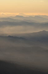 beautiful landscape view of guatemalan highlands mountains with pine trees and vulcan de agua volcano from acatenango basecamp (hike hiking trekking) famous travel destination sunrise sun shine trees
