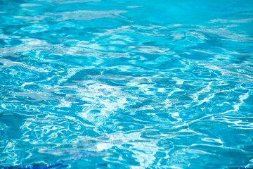 Fototapeta premium Ripped water in swimming pool. Surface of blue swimming pool, background of water.
