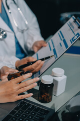 Male and female doctors are having a meeting in a hospital room.