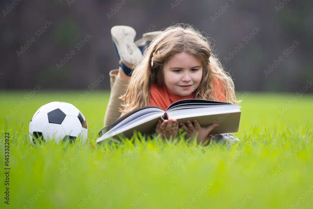 Poster child reading a book in the grass. kid enjoying a book story outdoors. child studying with book in t