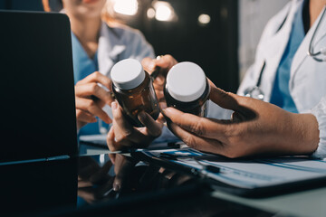 Male and female doctors are having a meeting in a hospital room.