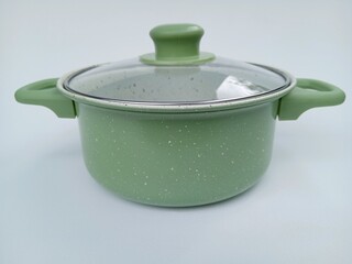 cooking utensils such as pots and pans in green with a white background