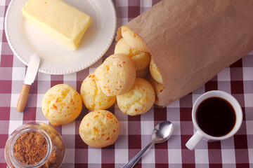 homemade cheese bread, traditional Brazilian snack, on the breakfast table in a rustic farm kitchen