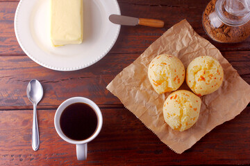 homemade cheese bread, traditional Brazilian snack, on the breakfast table in a rustic farm kitchen