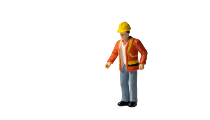 A construction worker figurine with a yellow helmet and orange vest
