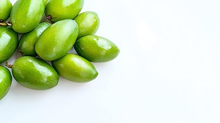 Obraz premium A cluster of glossy, green fruits rests on a white background, leaving ample empty space