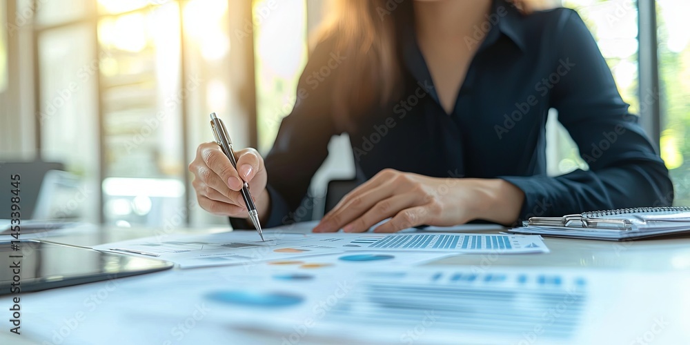Poster Business Professional Analyzing Reports and Making Notes on Financial Charts with a Pen in a Modern Office Setting During Daylight