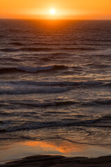Sunset over Pacific ocean at Oregon coast reflection in the water. © SNEHIT PHOTO
