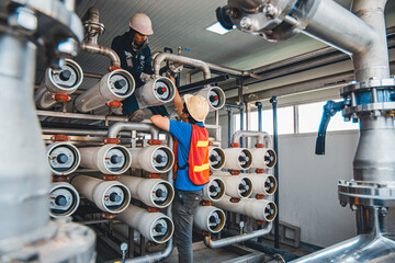 Male worker install is using Industrial oxygen tanks in chemical factory. Oxygen storage vessels, which is either held under pressure in gas cylinders, or as liquid oxygen