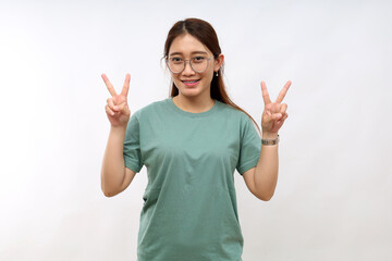 Positive charming asian woman showing victory peace signs looking camera happily smile enjoy...