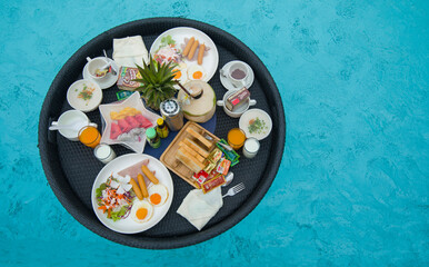 Breakfast on a plate in swimming pool