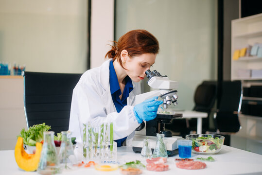 Scientist testing food samples in lab with microscope, vegetables, and meat for safety, nutrition, and biotechnology