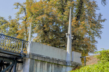 Bridge with gothic architectural details, surrounded by trees in an urban setting.