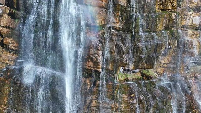 Aerial Bridal Veil Falls water Provo Utah close descend 1. 607 foot tall double cataract waterfall in Provo Canyon. Rugged rocky ledges and cliffs over pine forests. Deep canyon valley. Summer.