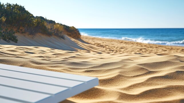 Beach vista with sand dunes, ocean waves, and a white table in the foreground