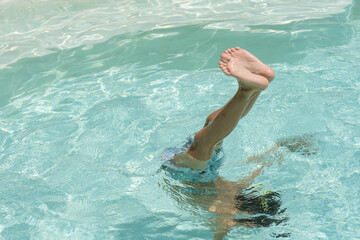 baby's feet out of water in pool	