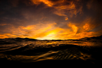 Golden sunset over the ocean as seen from the surface off Sydney, Australia.