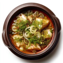 Overhead view of delicious fish dish with herbs, onions, and spices