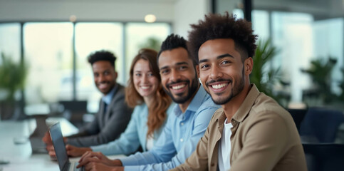 Obraz premium A diverse group of confident professionals smiling in a bright modern office, exuding positivity and tech-savvy collaboration.