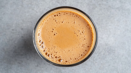 Rich Vietnamese coffee with creamy foam in glass, showcasing its inviting texture and color