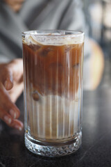 Refreshing iced coffee served in a glass on a smooth table