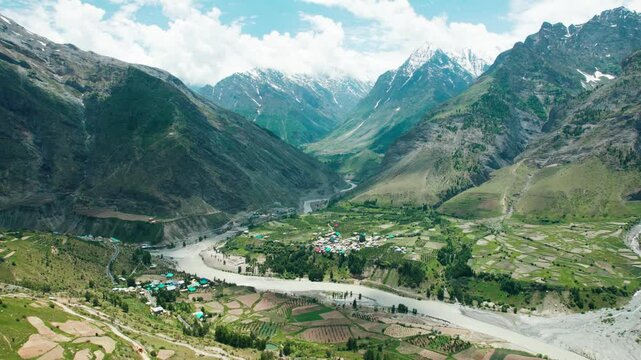 4K Aerial shot of Chenab river flowing in mountain valley as seen from Marbal Village in Lahaul, Himachal Pradesh, India. Aerial view of beautiful Himalayan mountains and Chenab river.