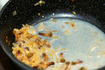 Rendered pork fat solidified in a skillet with crispy cracklings, showcasing traditional cooking fat preparation