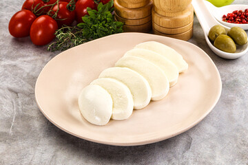 Organic mozzarella cheese slices in the plate
