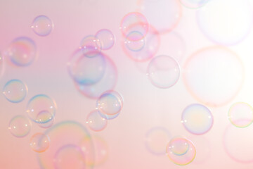Beautiful Colorful Transparent Soap Bubbles Floating in The Air. Celebration Festive Backdrop. Freshness Soap Suds Bubbles Water. Gradient Colors Pink and White Textured.