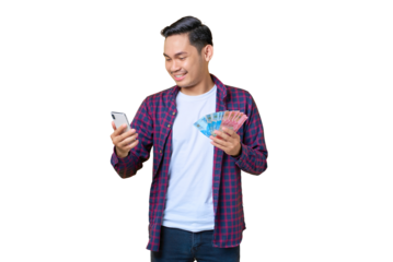 Smiling young Asian man in plaid shirt using mobile phone and holding money banknotes isolated on transparent background